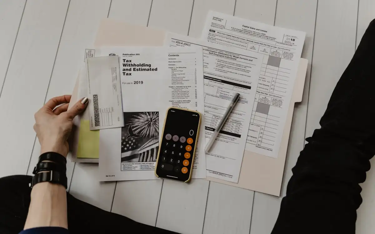 Financial paperwork and a calculator laid out on a desk