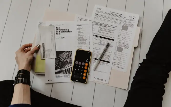 Financial paperwork and a calculator laid out on a desk