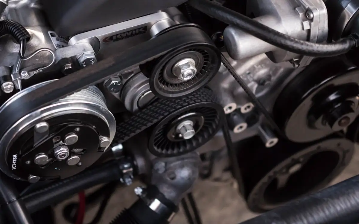 Close-up of an engine bay showing belts and pulleys that transfer power