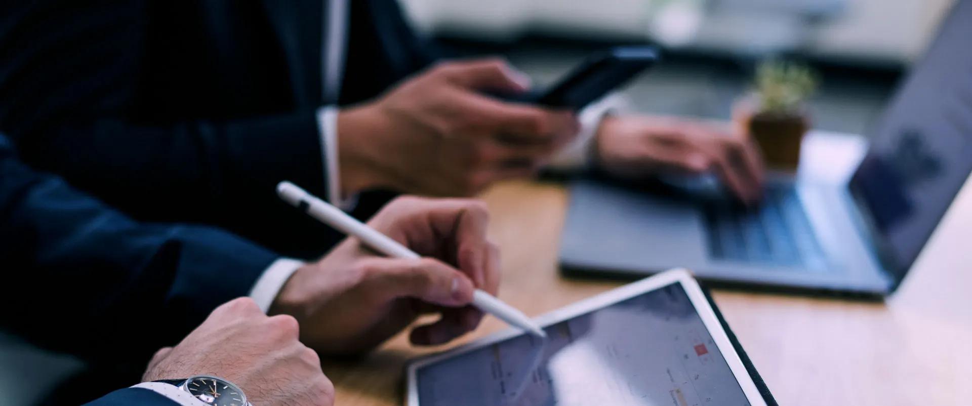 Business professional working at a laptop and tablet