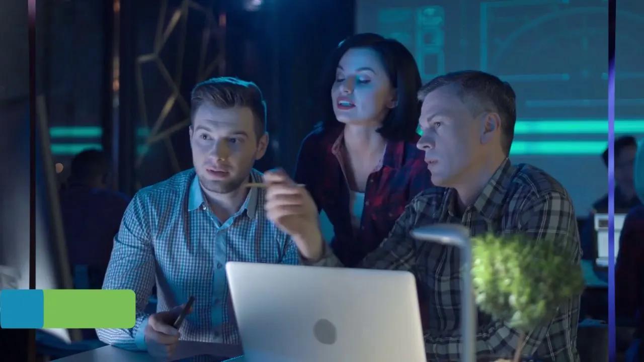 TelcoSolutions team reviewing a laptop together