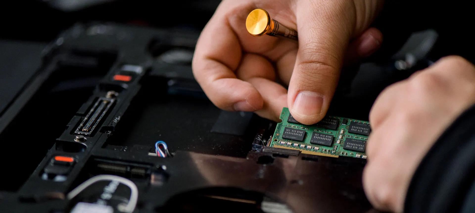Technician installing a memory module in a business server