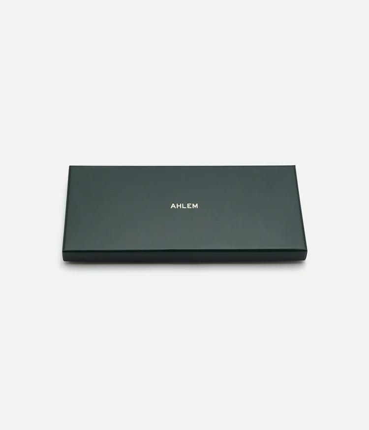 AHLEM Atelier Scarf — product shot on grey ground showing the hand-rolled edge and silk drape