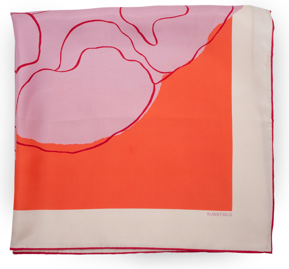 The Poppy scarf folded, showing the flower’s form against the coral ground