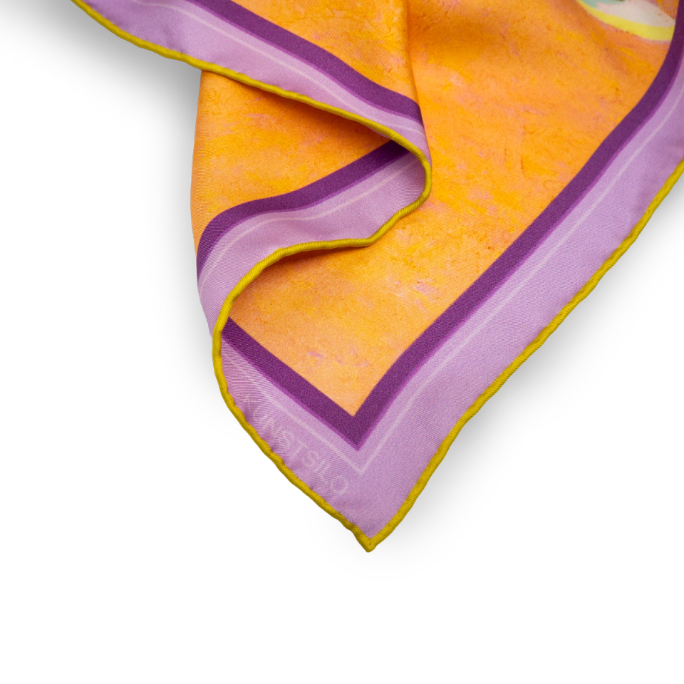 Corner detail of the Carlstedt Stillife scarf — the lavender border and warm amber ground