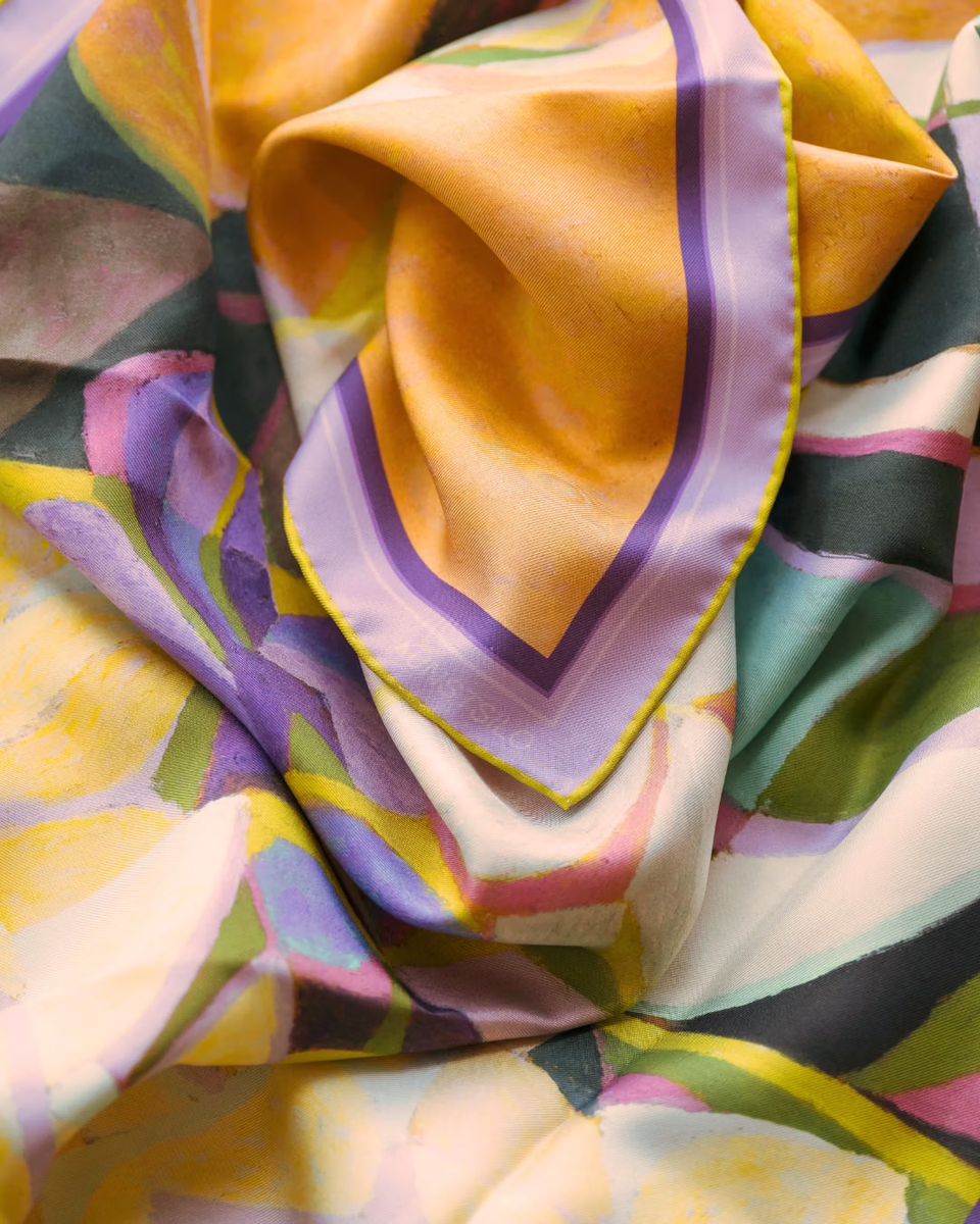 The Carlstedt Stillife scarf draped in soft folds — the silk’s sheen catching the painting’s rich palette