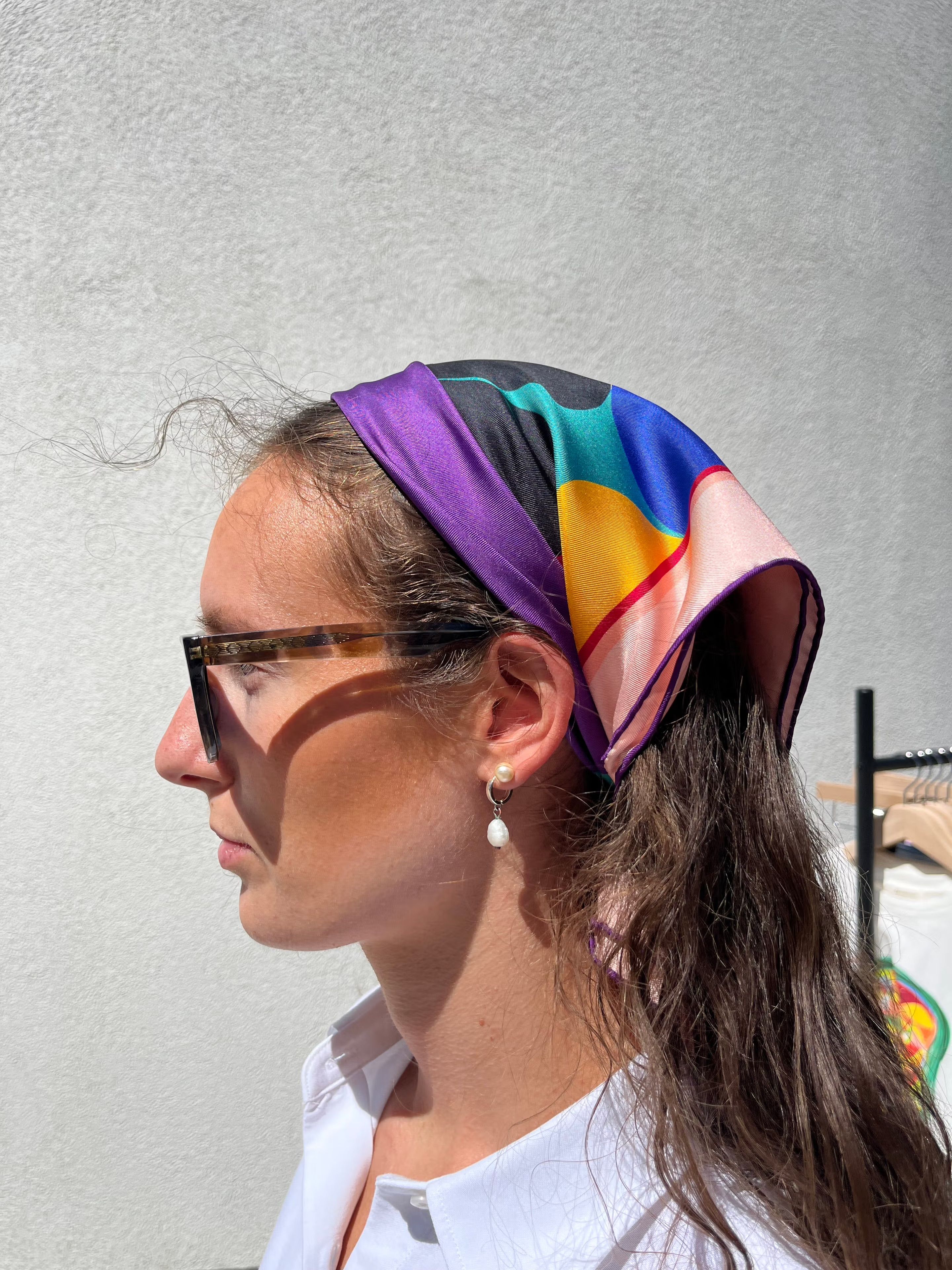 The Gundersen scarf worn as a headband — the bright colourblocks framing the face