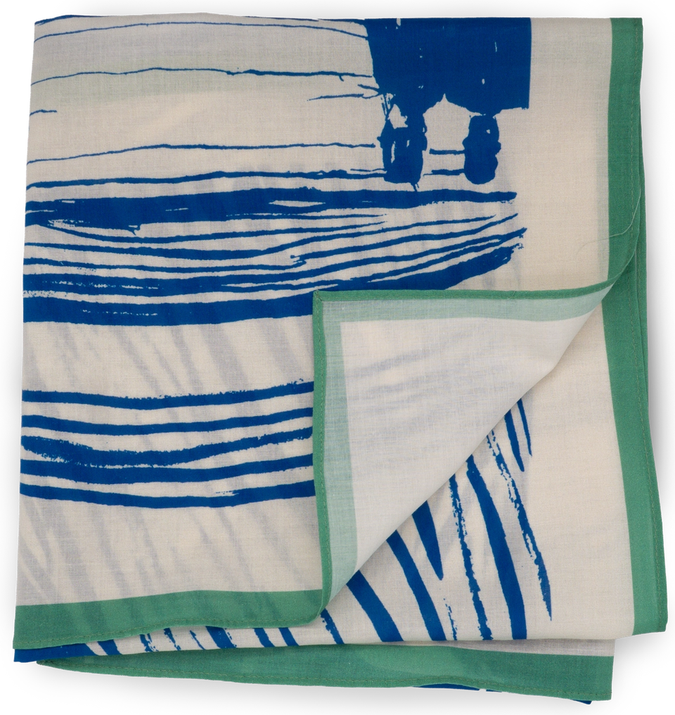 The Skrik scarf folded flat — Munch’s expressionist image in blue and cream, the horizontal stripe composition visible front and back, with a green rolled edge