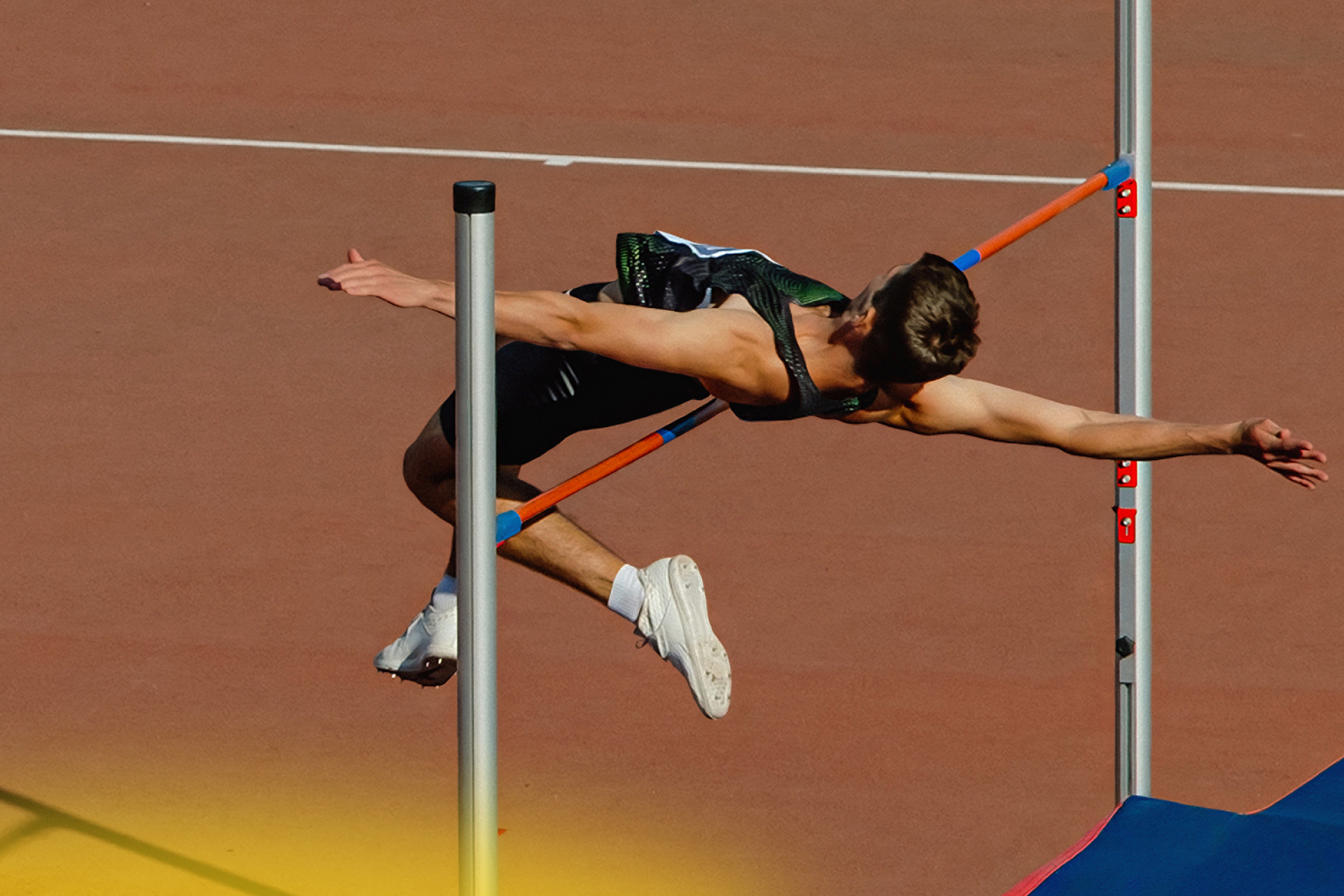 Man jumping a bar in the sport of high jump 