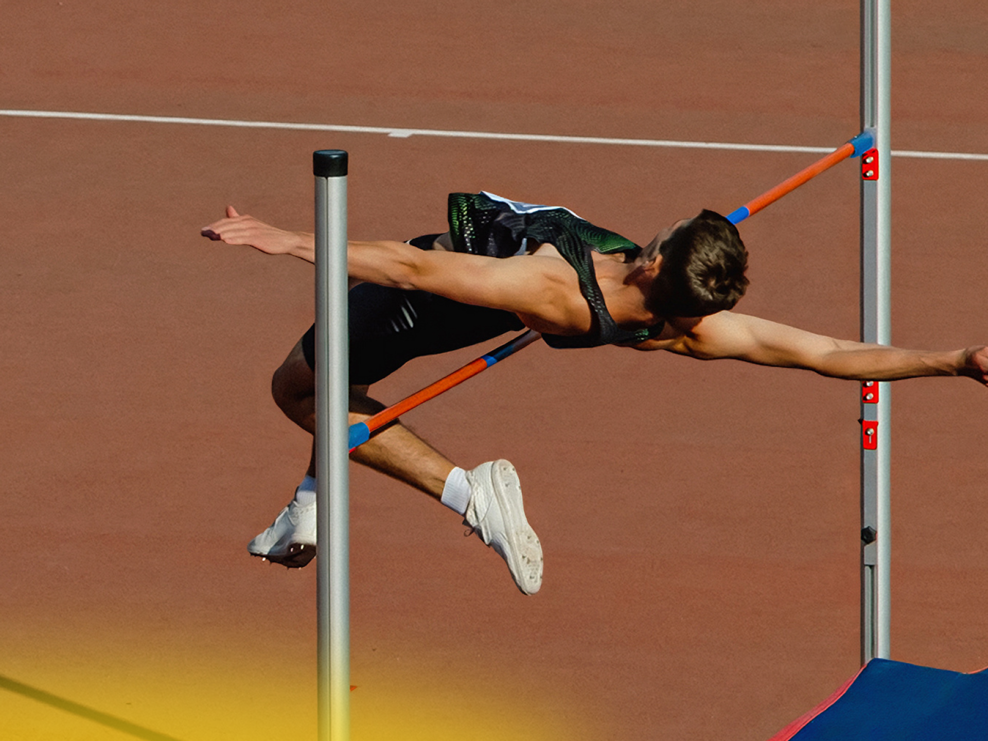 Man jumping a bar in the sport of high jump 