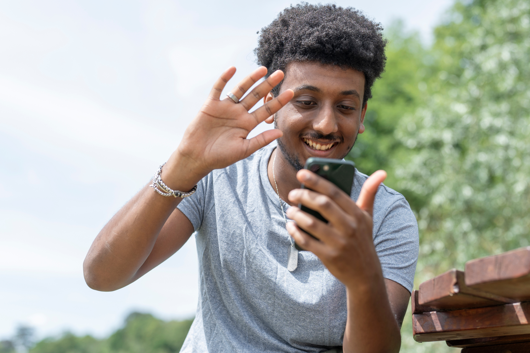 young man waving during a video call