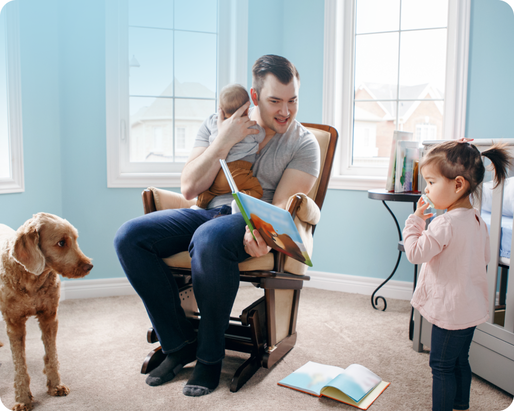 man at home with 2 kids and a dog