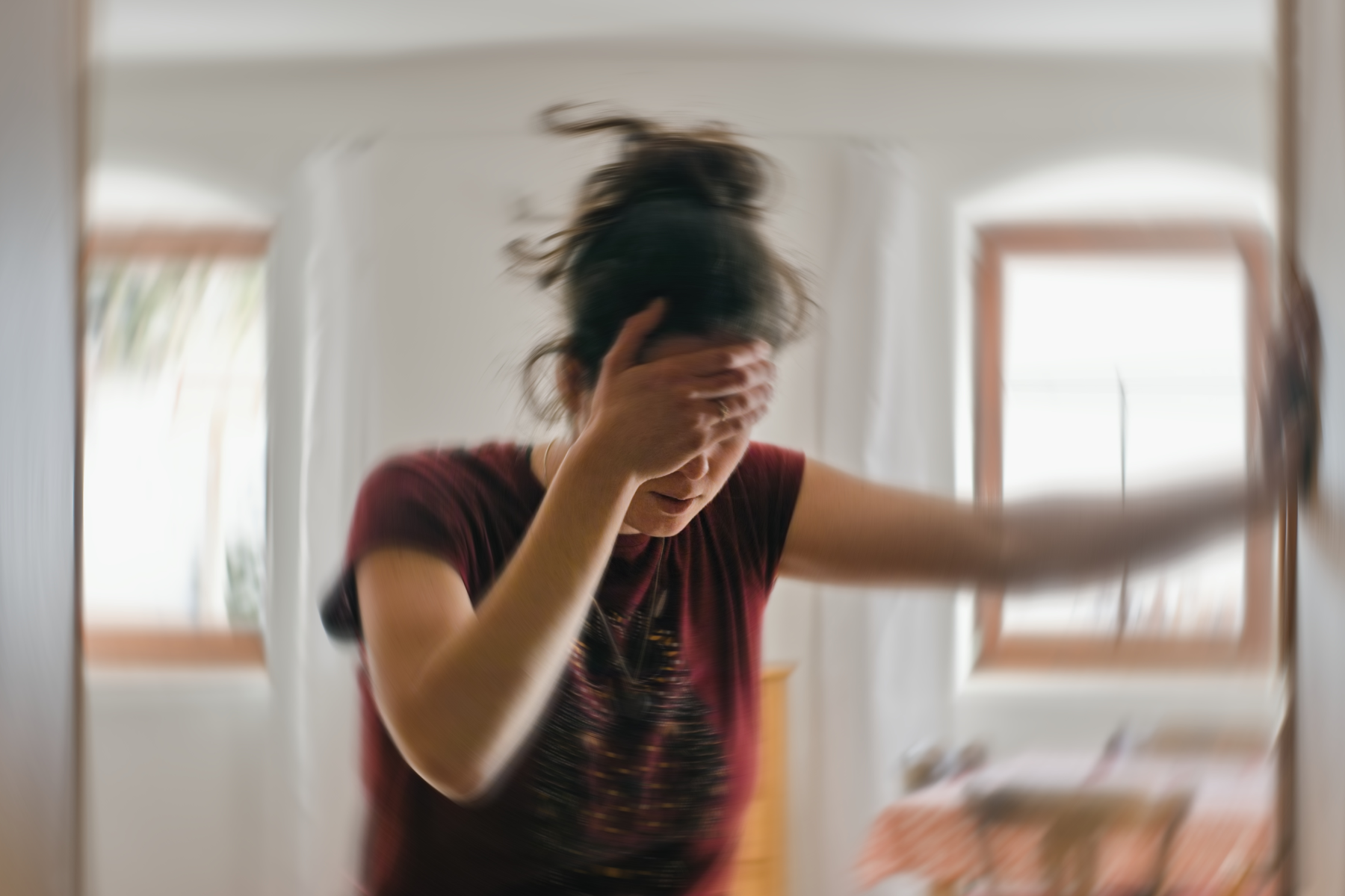 someone dizzy, holding a wall