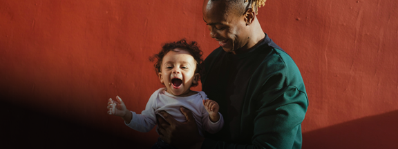 Man holding baby, happy