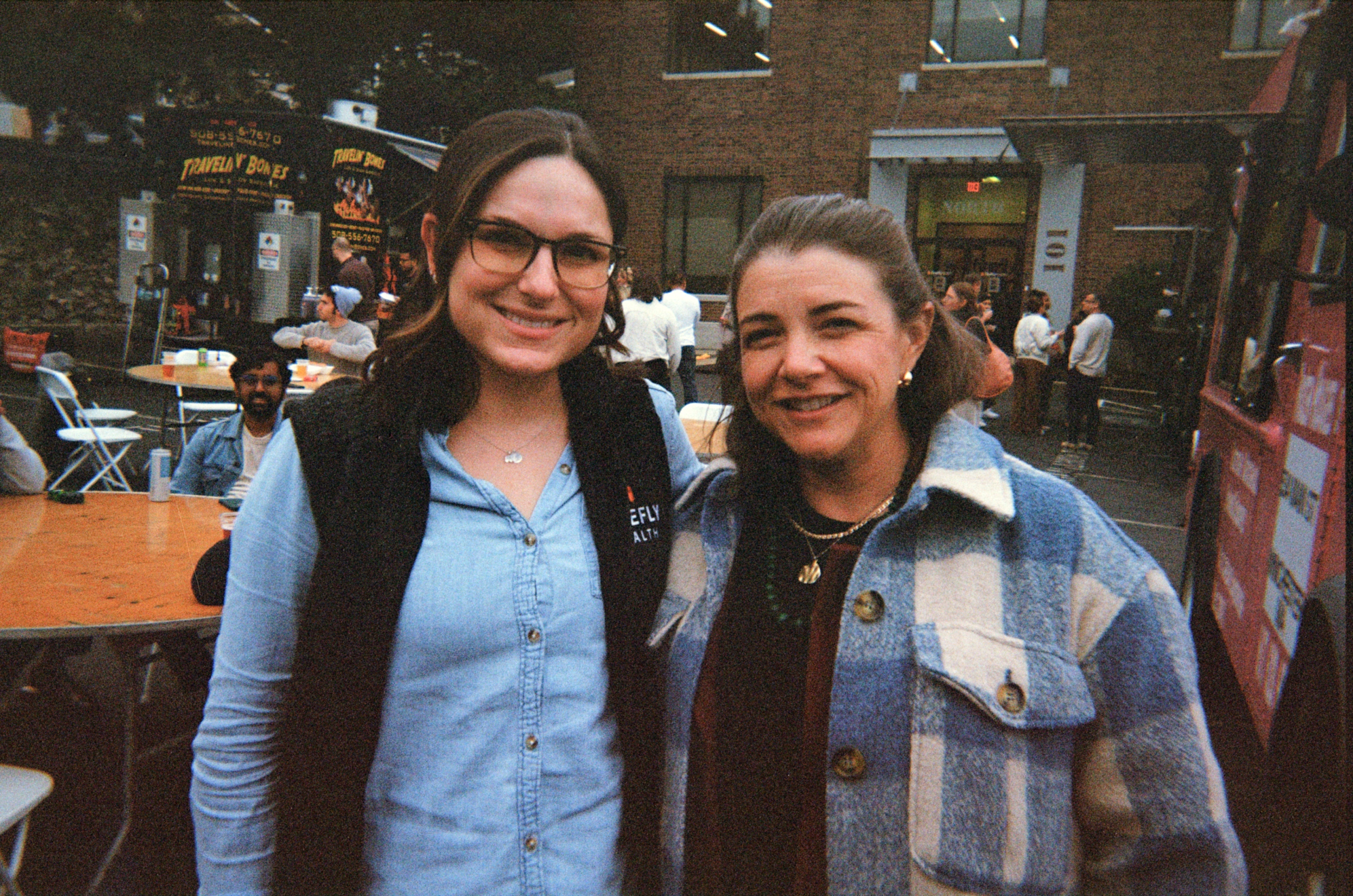 2 firefly employees outside smiling at a firefly food truck event 