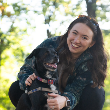 Carlie outside with her dog 