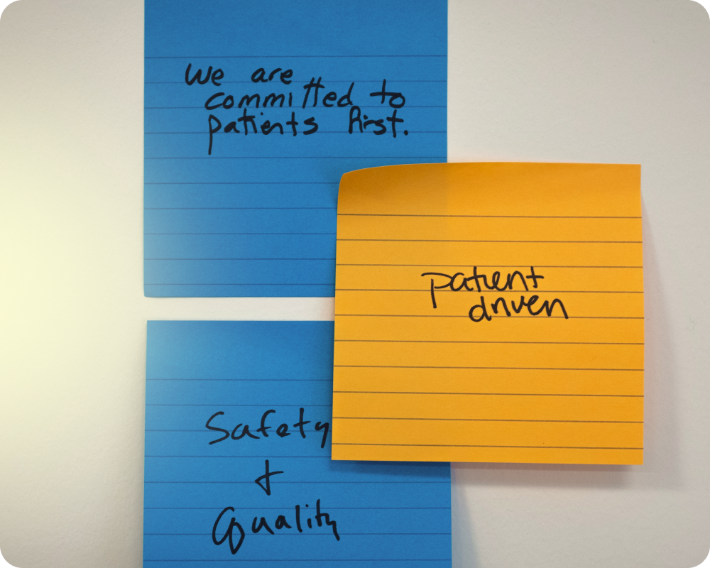 sticky notea with "we are committed to patients first", "safety + quality" and "patient driven" written on it