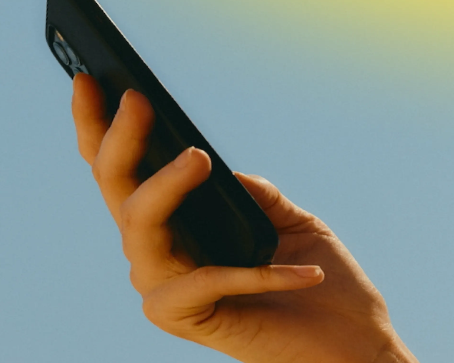 photograph of a hand holding a phone