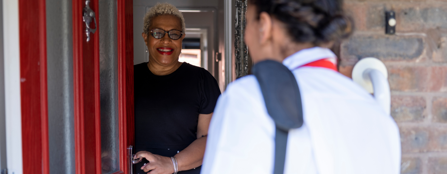 A woman opening the door for a travel nurse