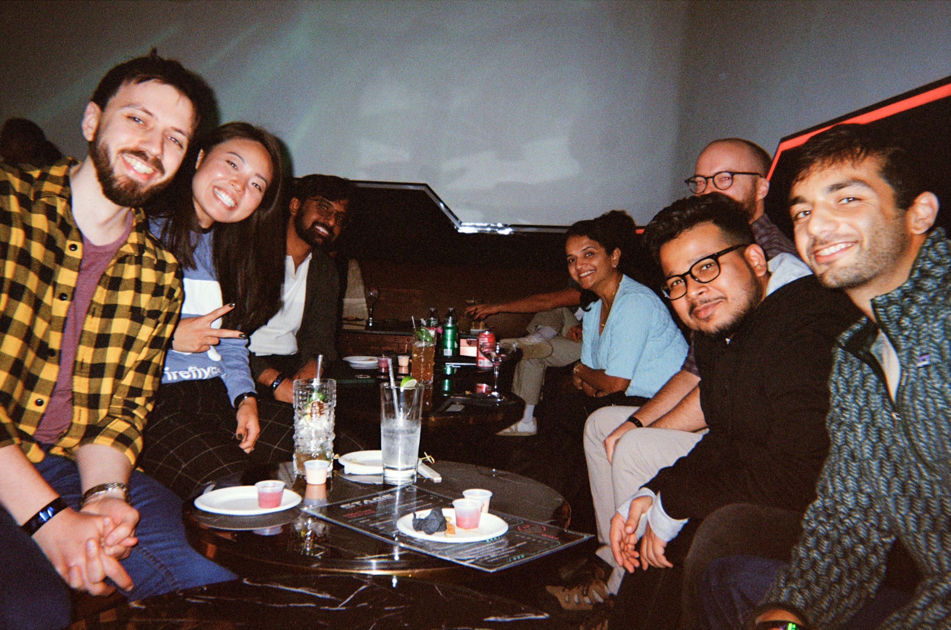 photograph of Firefly team members after work around a table 