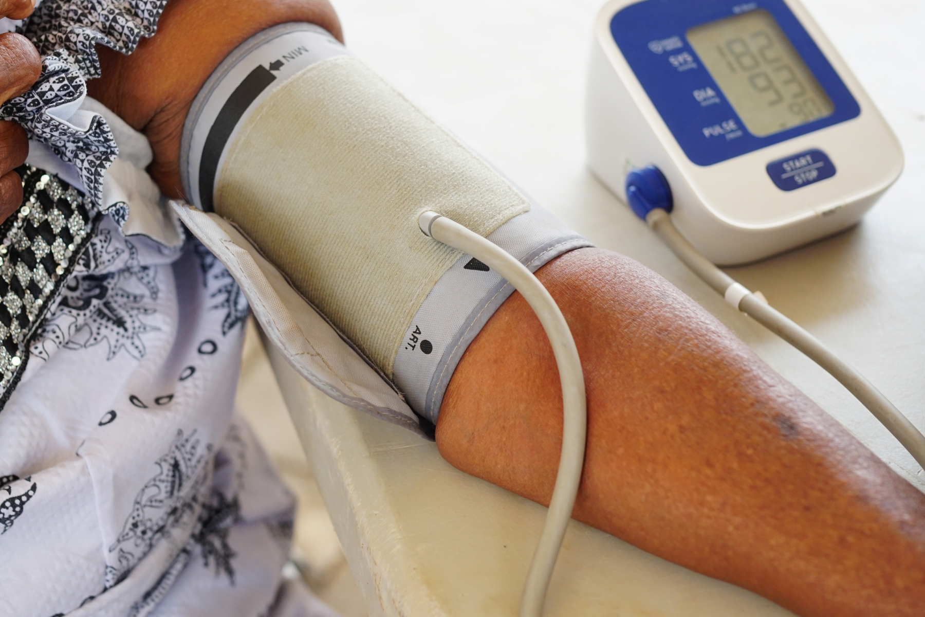 female checking her blood pressure from home