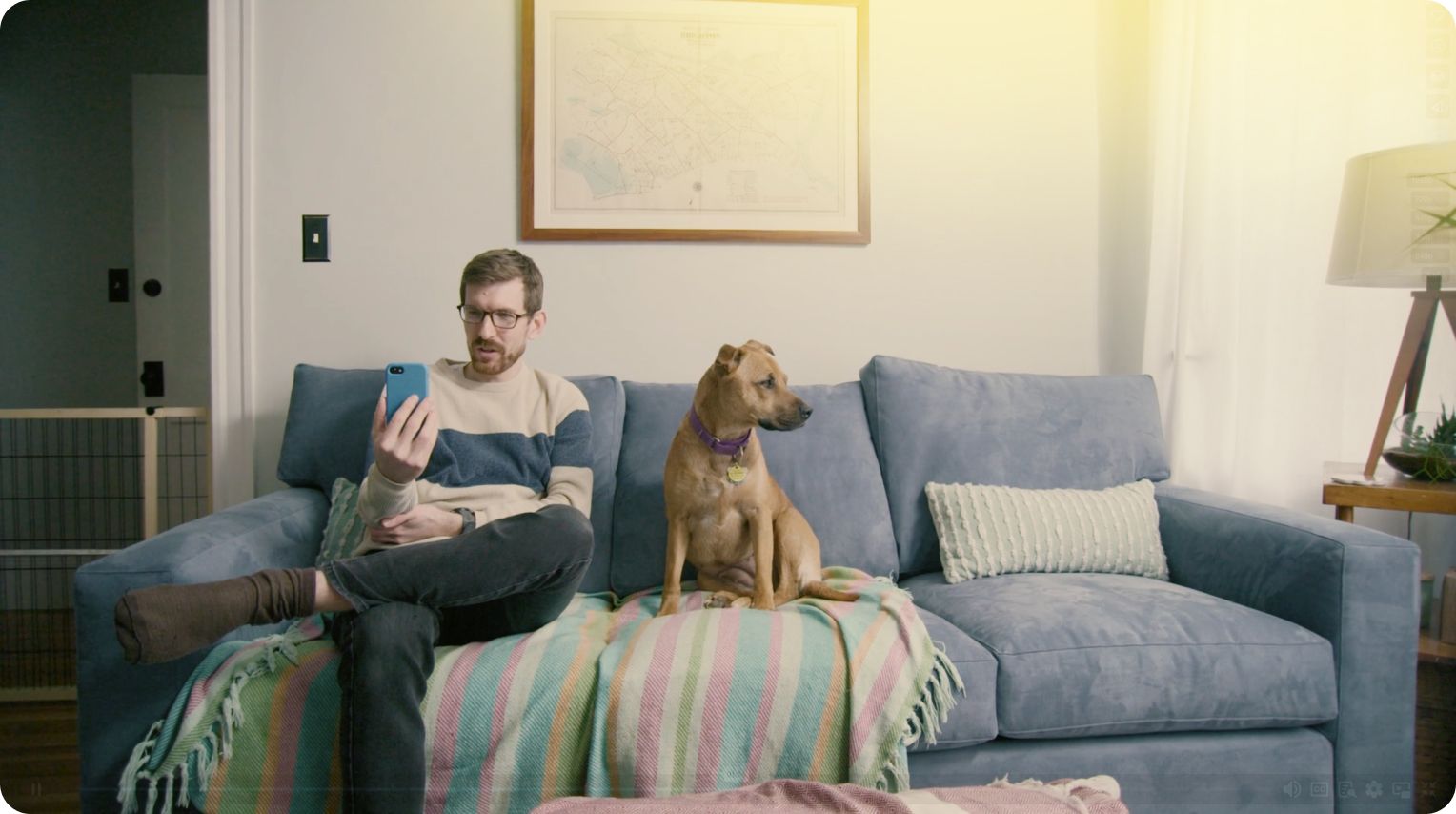 Keegan on couch with dog, video chatting 