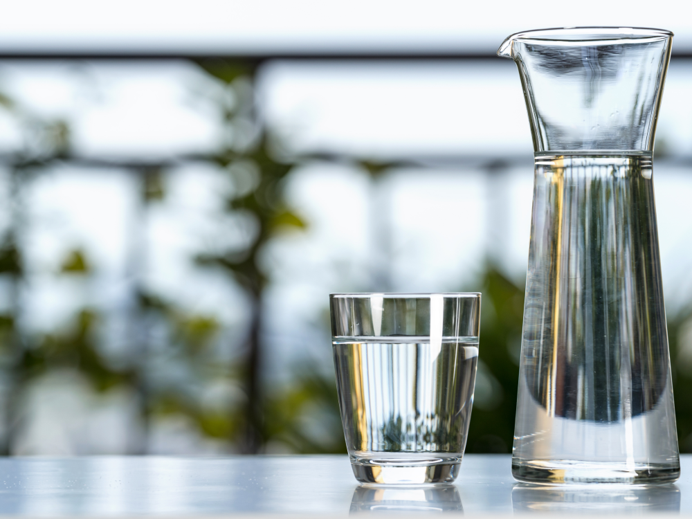 A glass and pitcher filled with water
