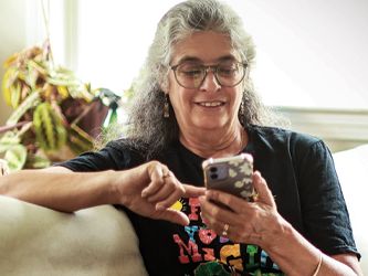 Adult female with glasses using a smart phone