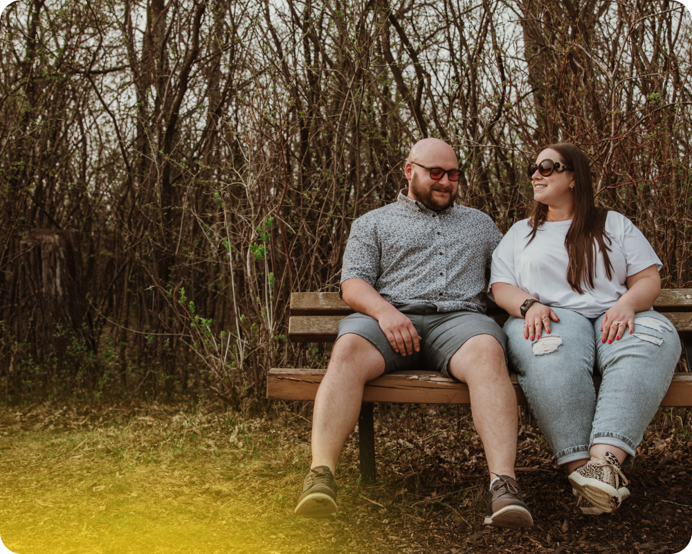 couple sitting on a bench outside 