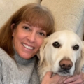 Headshot of Deb holding her dog