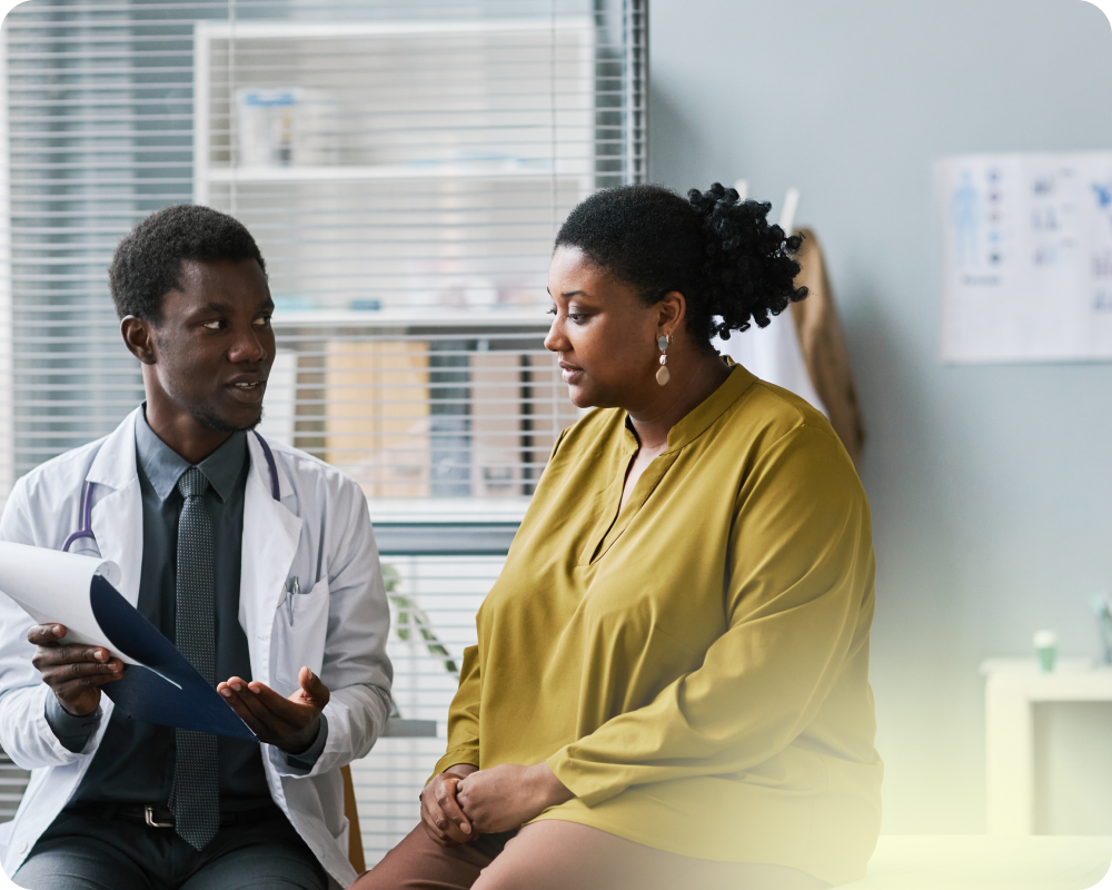 photo of a woman at the doctors office talking to a physician 