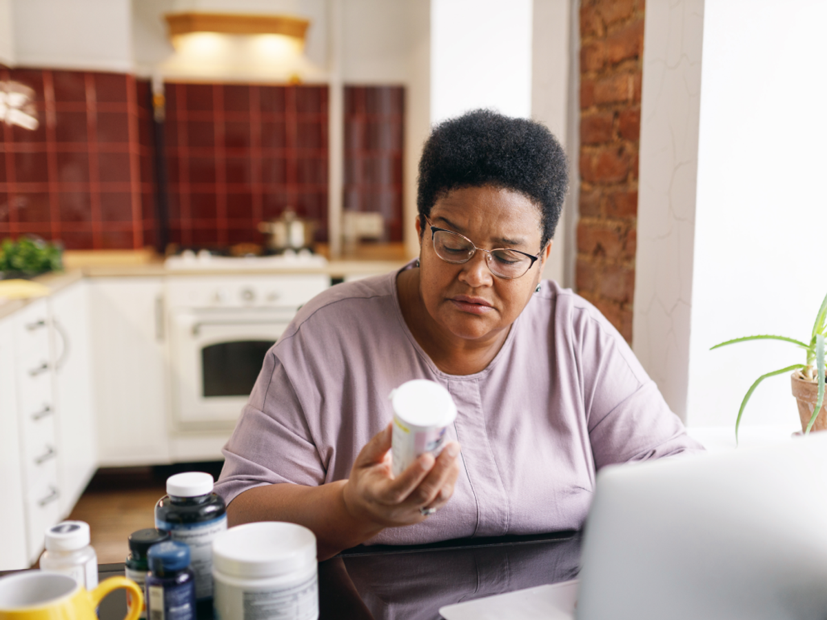 Image of an African American looking at blood pressure medications