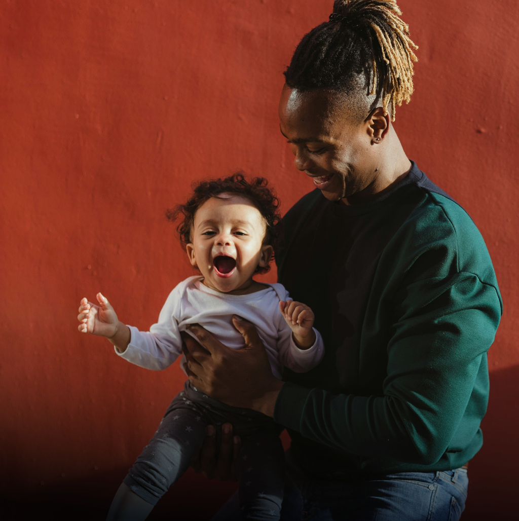 Man holding baby, happy