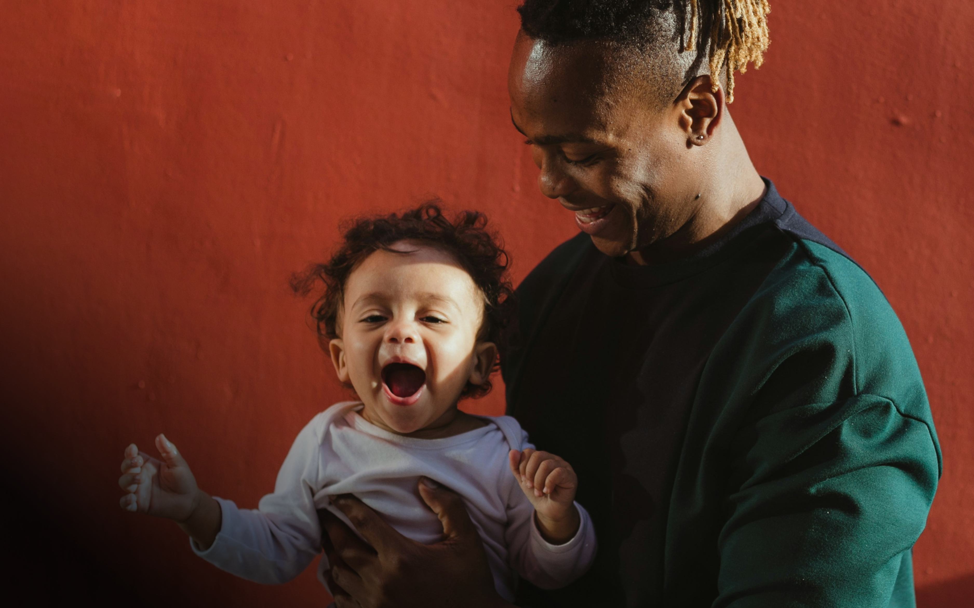 Man holding baby, happy