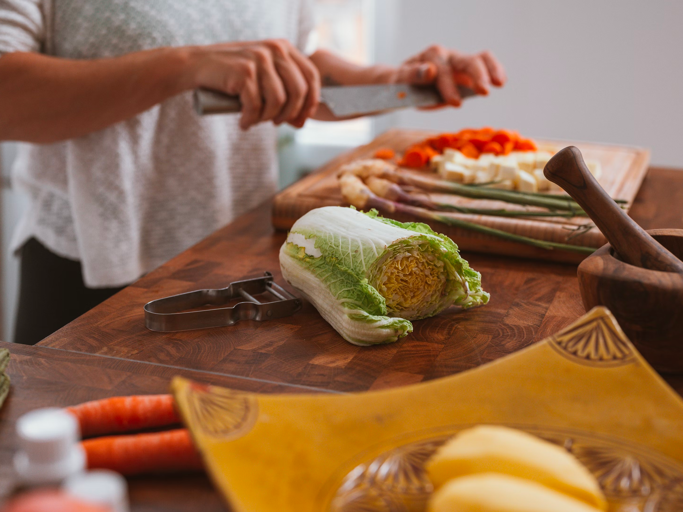 A kitchen countertop with chopped vegetables