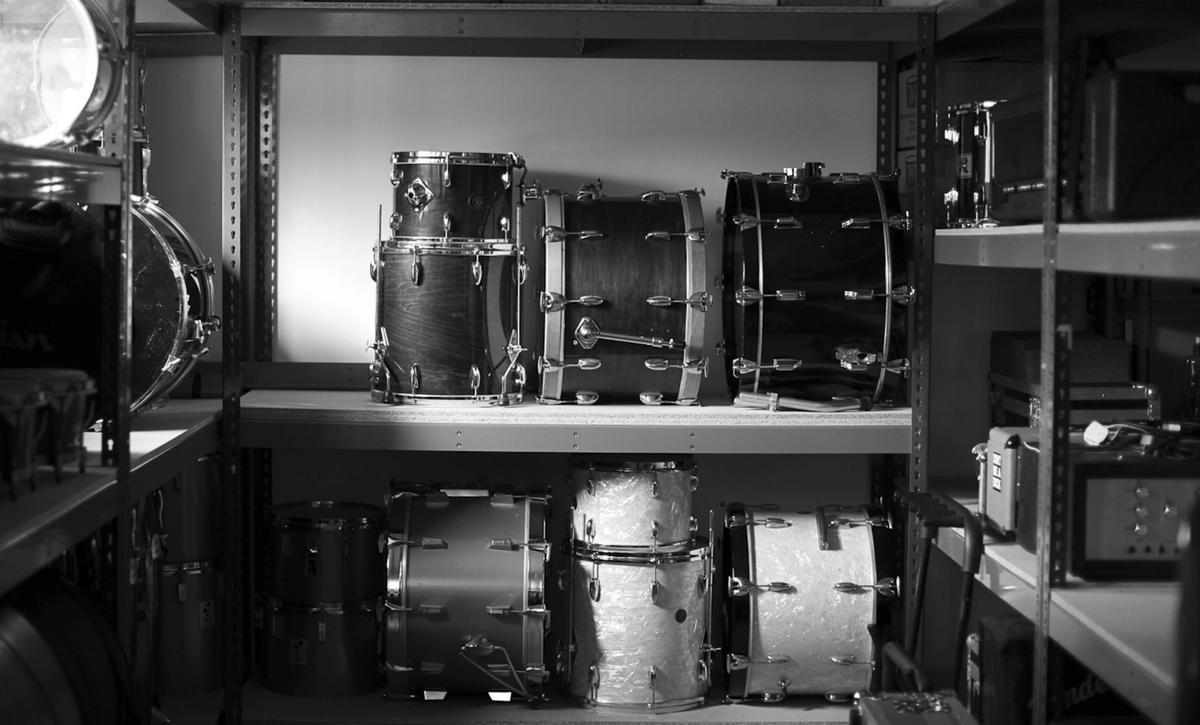 Vintage drums on shelves in storage