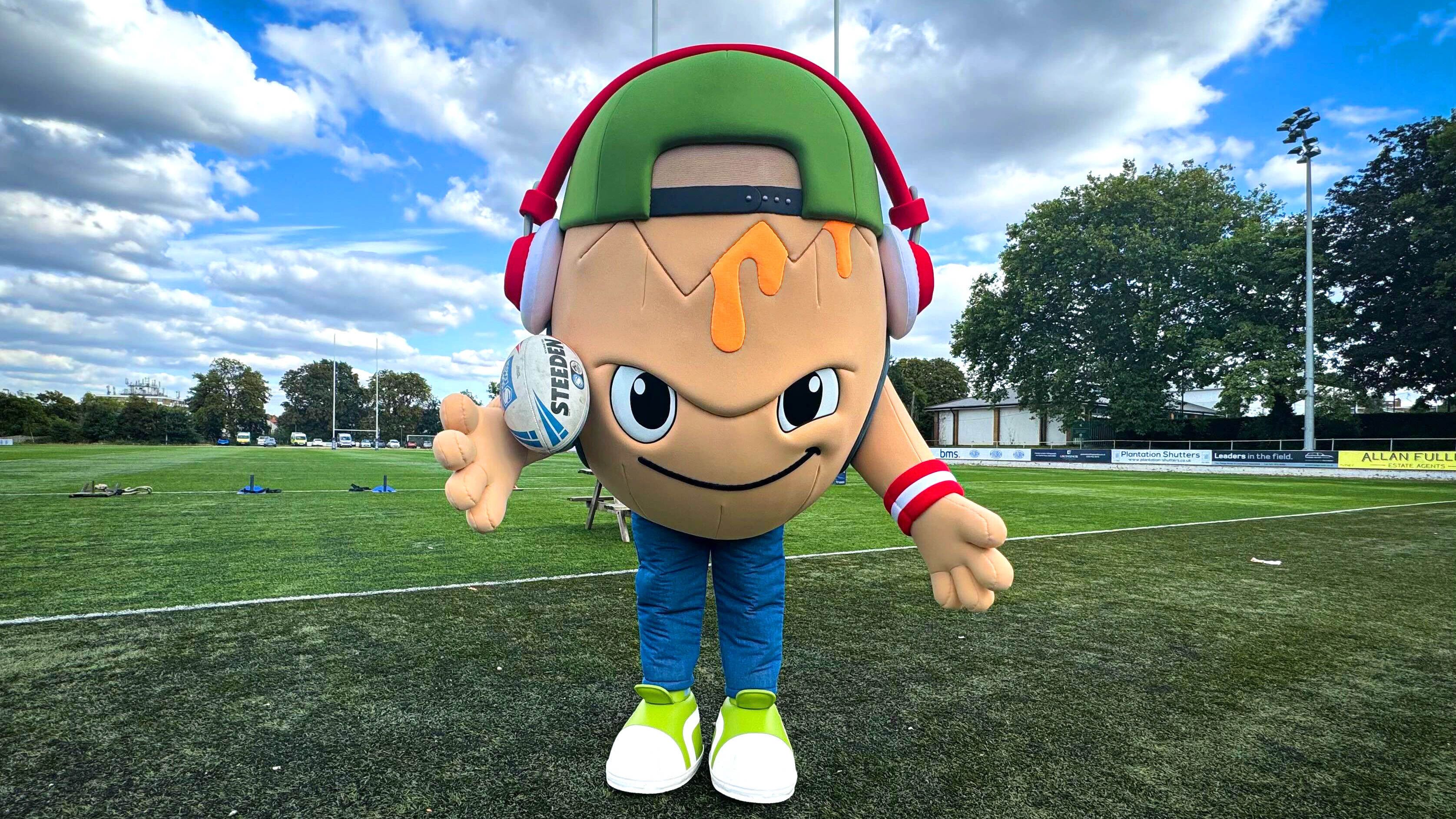 Chief Egg and Benny carrying out the game ball at London Broncos vs Rhinos