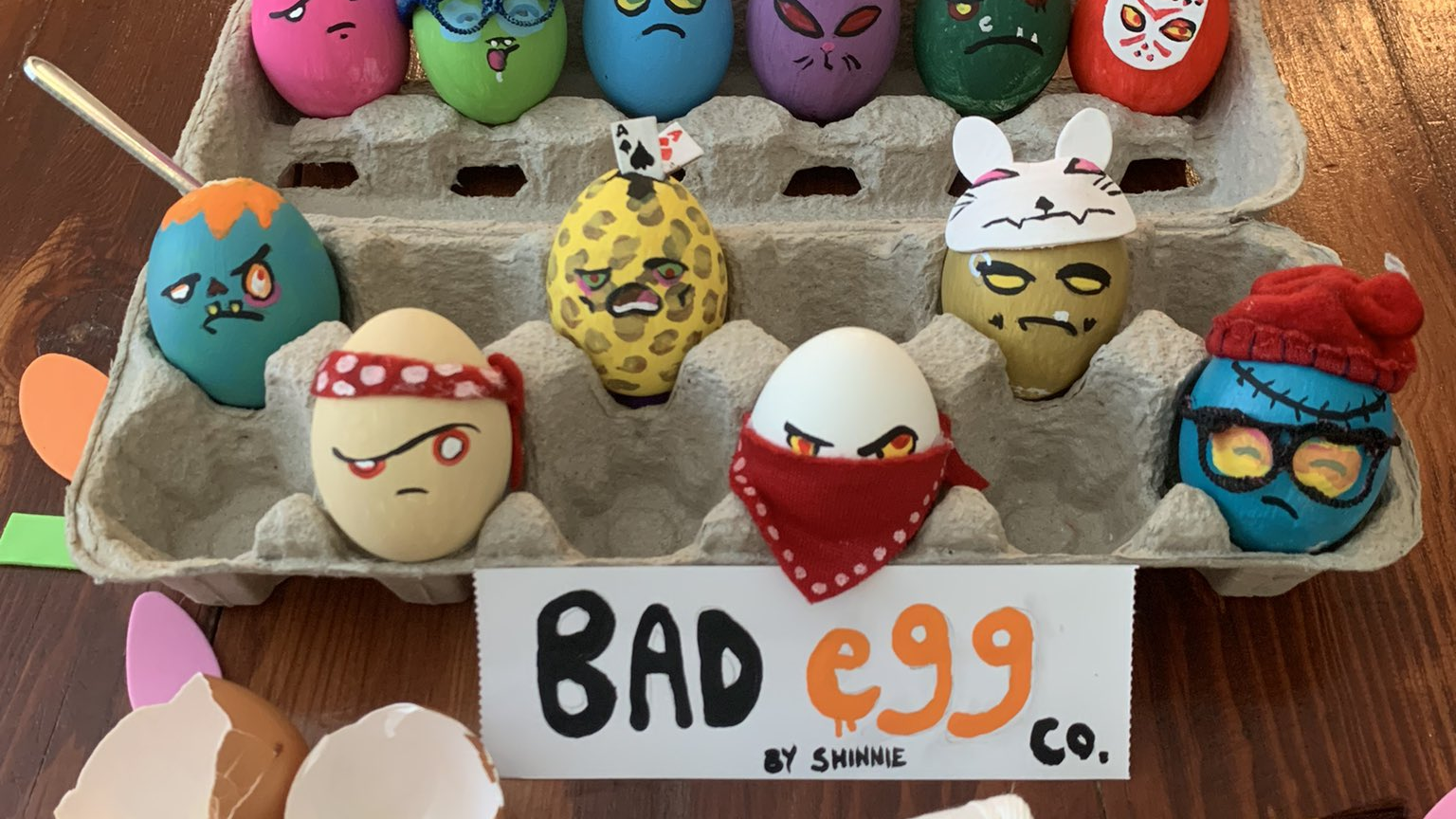 Dozen decorated eggs with a golden egg standing out