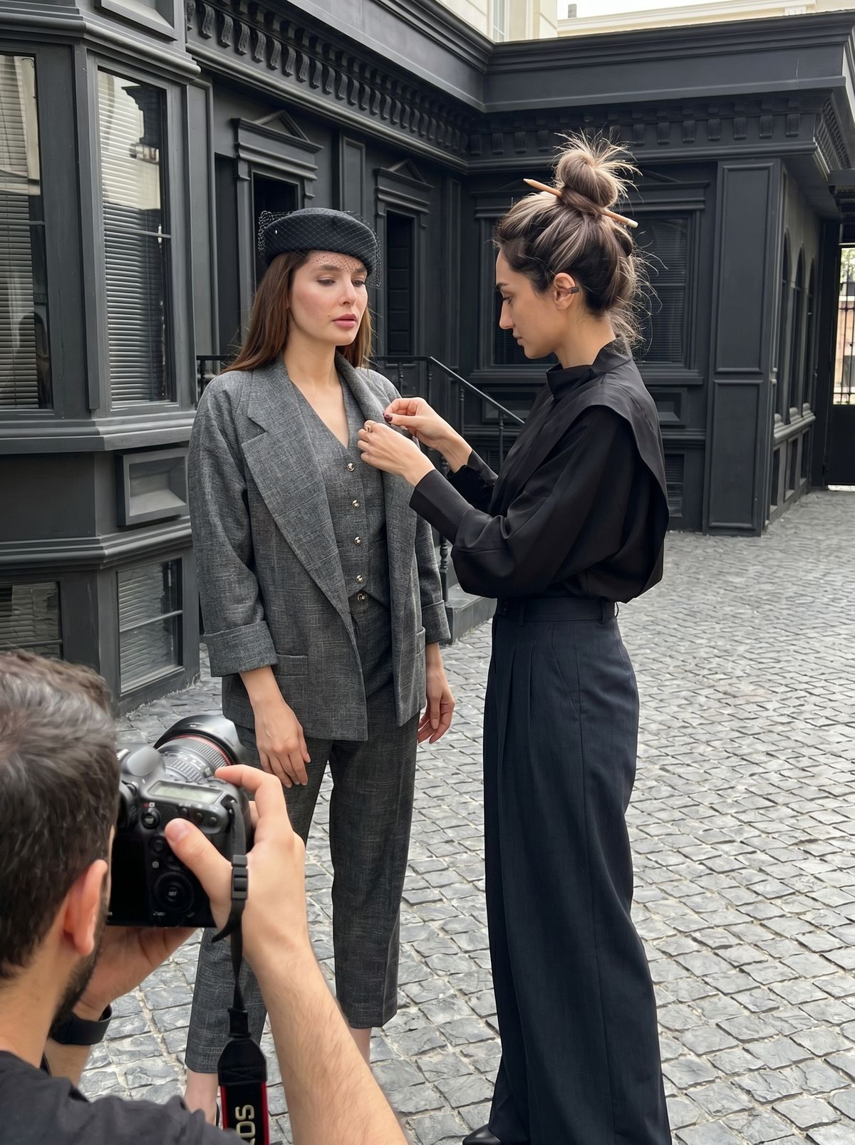 Luxury editorial fashion model wearing modern designer outfit in urban street style photoshoot
