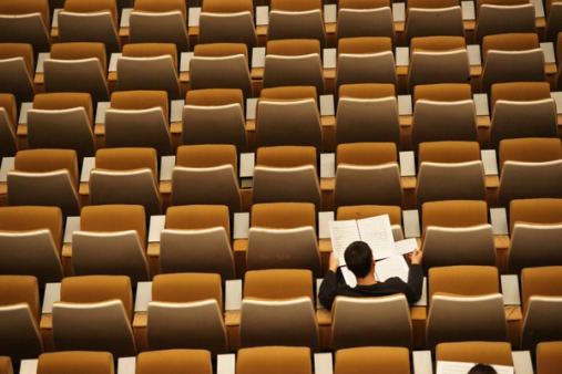 Student in empty lecture hall