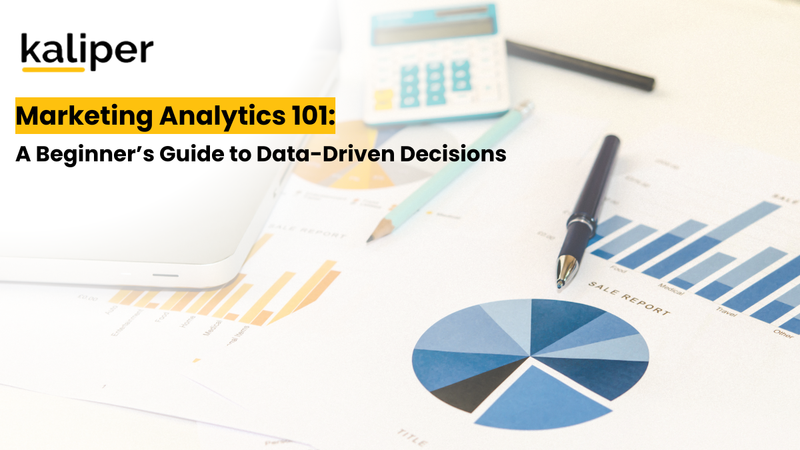Blog header graphic titled "Marketing Analytics 101: A Beginner's Guide to Data-Driven Decisions," showing a laptop and calculator beside printed sales reports with bar and pie charts.