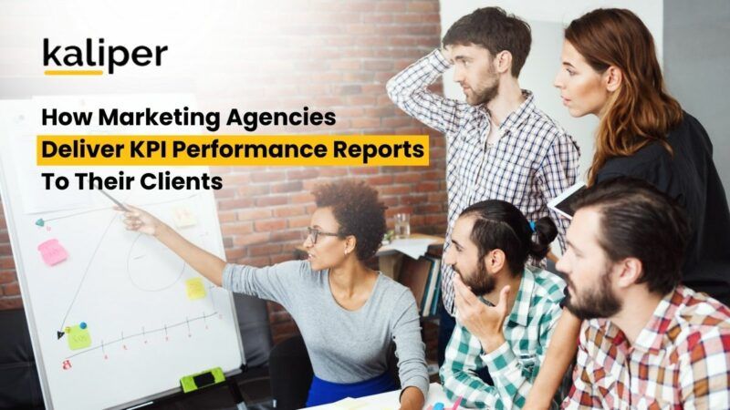 Blog header graphic titled "How Marketing Agencies Deliver KPI Performance Reports To Their Clients," showing a woman presenting a hand-drawn chart on a whiteboard to a group of colleagues.