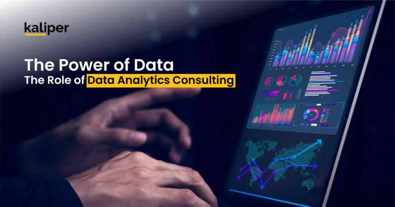 Blog header graphic titled "The Power of Data: The Role of Data Analytics Consulting," showing hands reaching toward a tablet displaying colorful bar charts, pie charts, and a world map with a growth arrow.