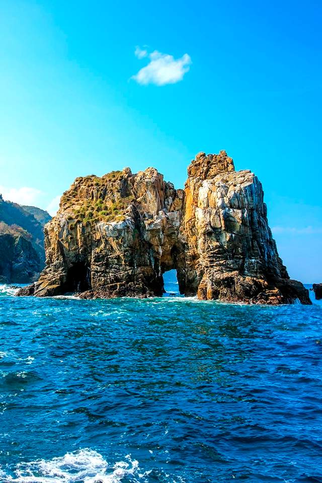 Las Iglesias rock formations rise from the ocean near Chimo, a popular diving spot in Puerto Vallarta.
