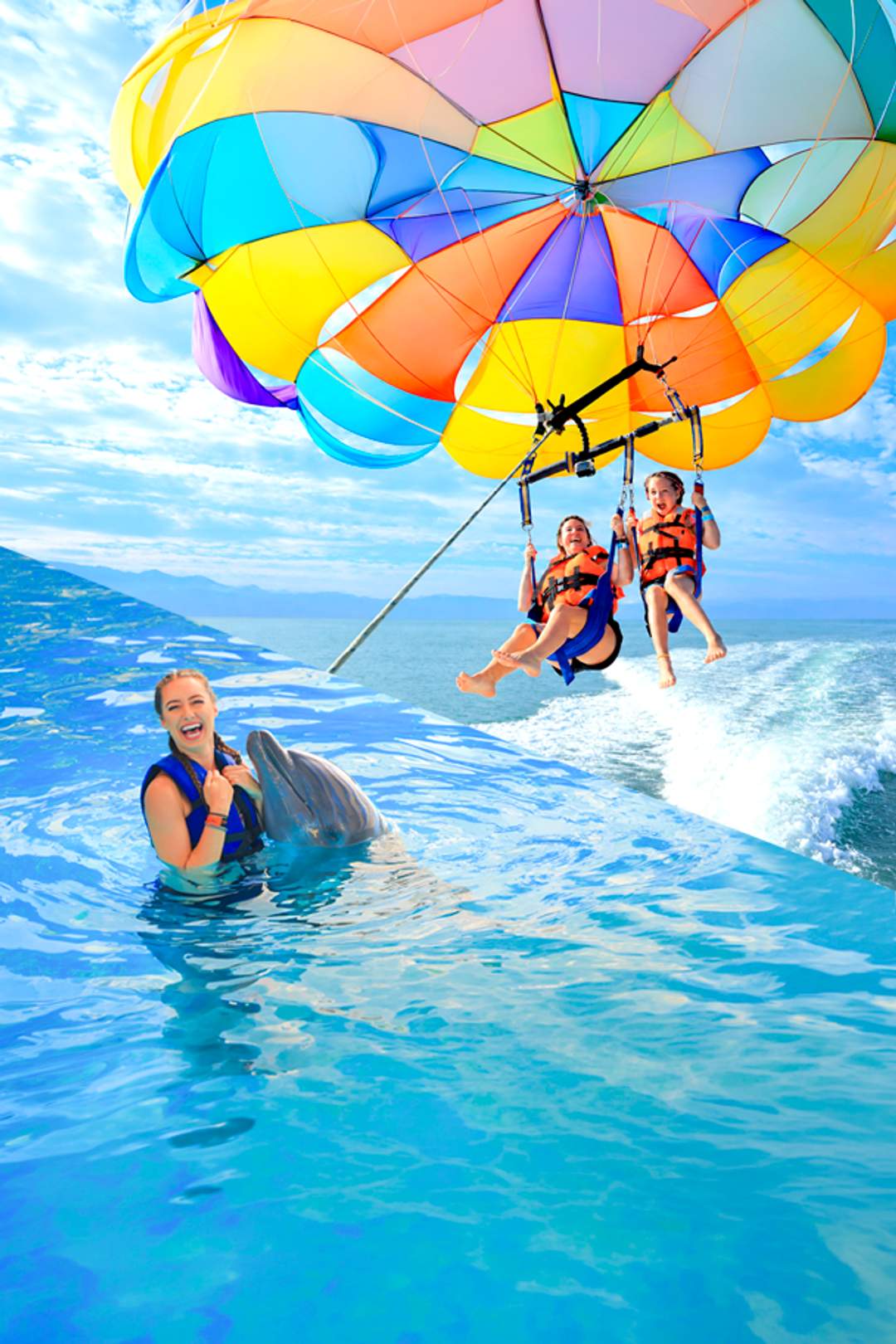 Fly on a parasailing and swim with dolphins in a Puerto Vallarta tour package.