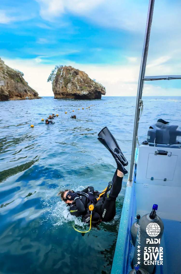 PADI diver entering the waters of Los Arcos during scuba certification dives in Puerto Vallarta