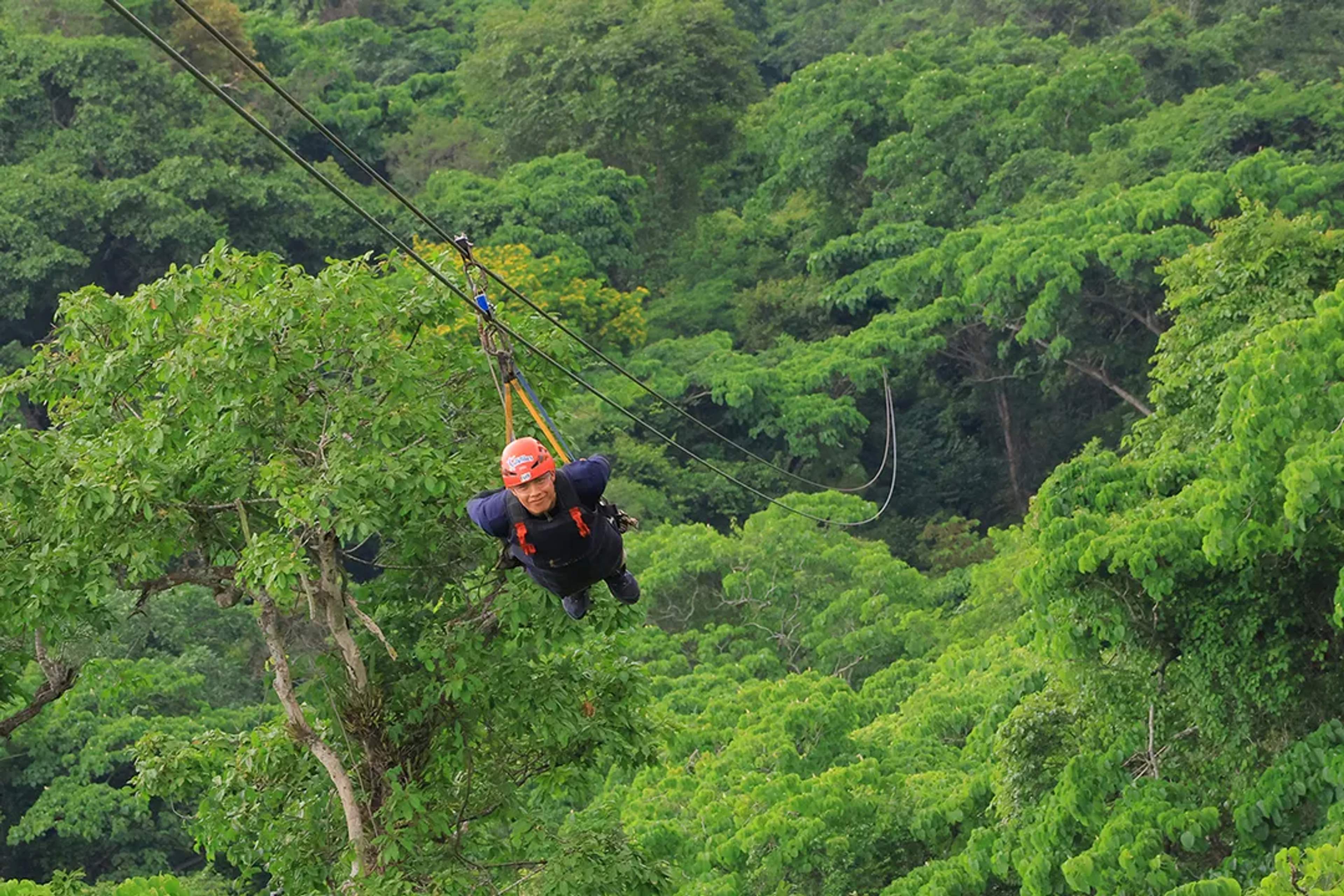 Superman-style zipline flight over the lush jungle of Puerto Vallarta during an outdoor adventure experience