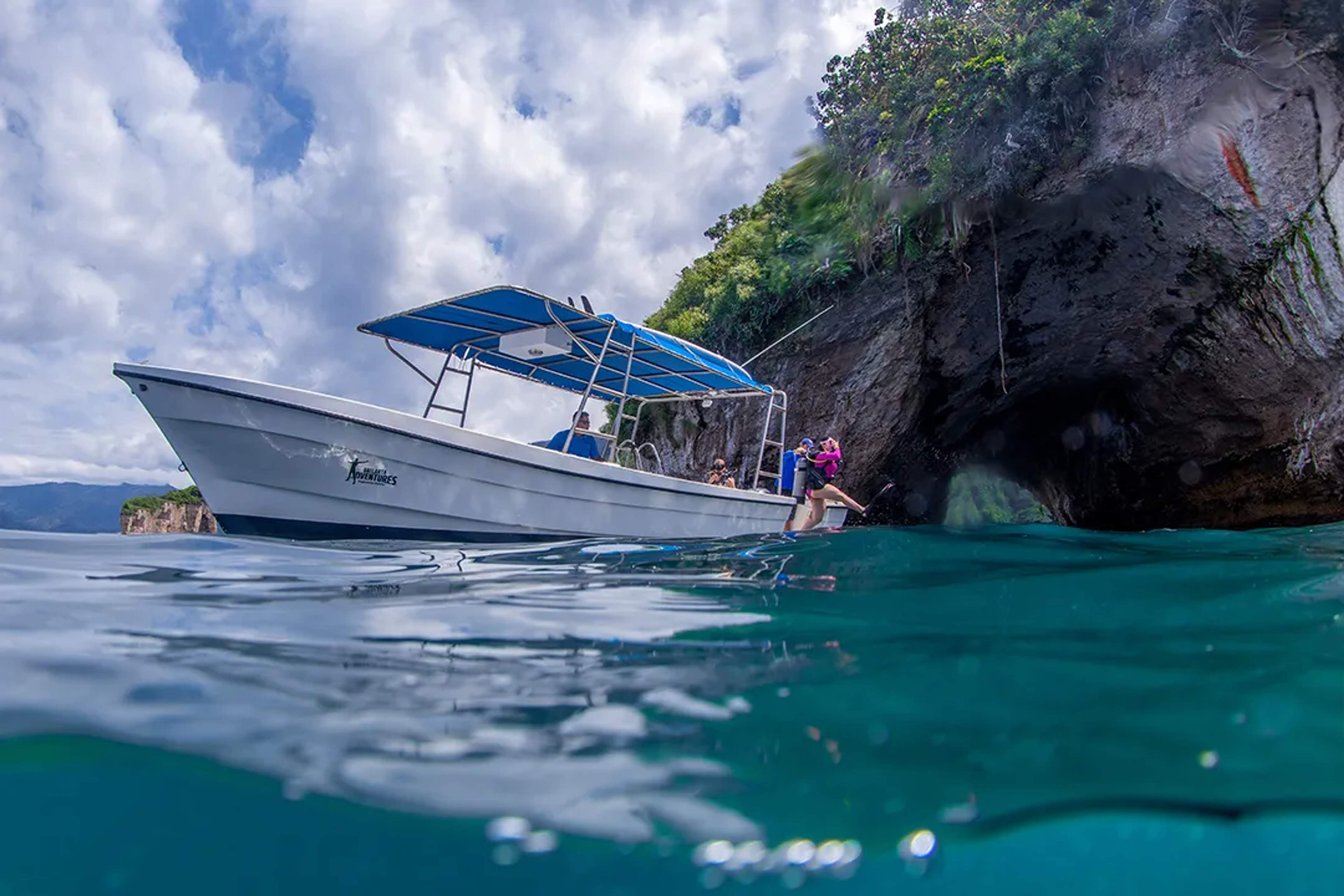 Snorkeling tour to Los Arcos in Puerto Vallarta with boat near sea cave and emerald waters