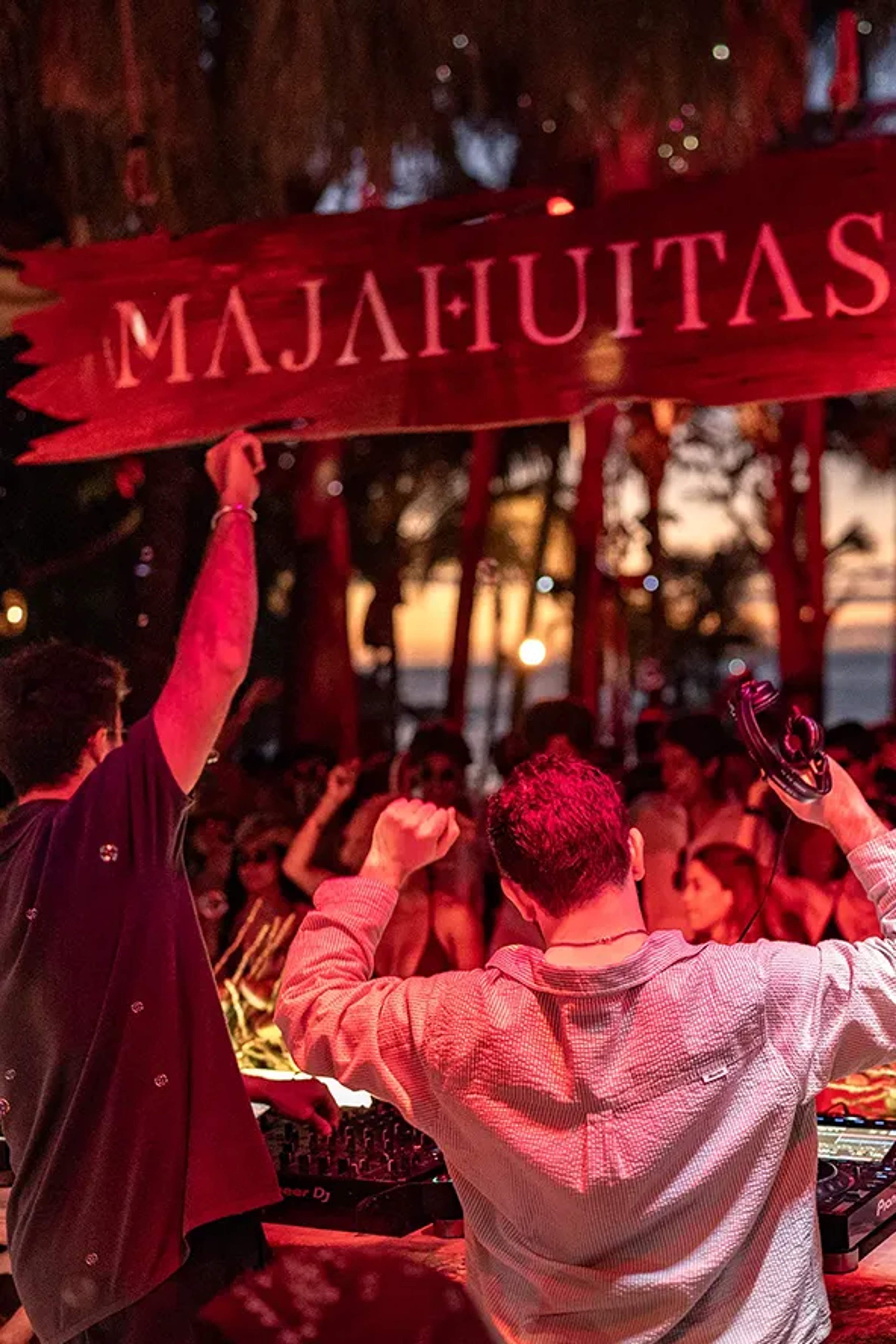 DJ and guests dancing at Majahuitas Beach Club in Puerto Vallarta during a lively adults-only night party.