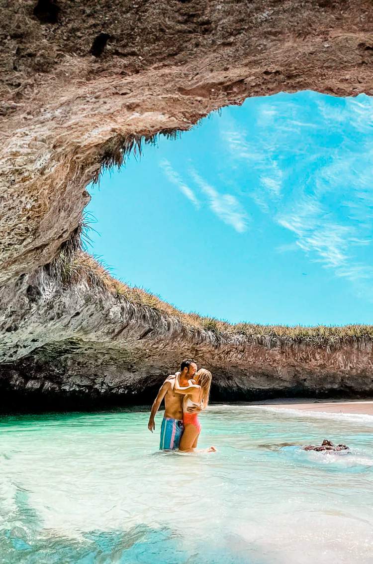 A couple embraces in the clear waters of Hidden Beach, Marietas Islands.